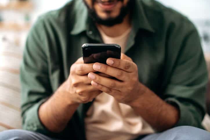 Digital marketer holding a smartphone after social media marketing training