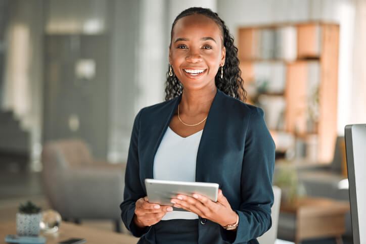 A smiling female social media specialist in an office