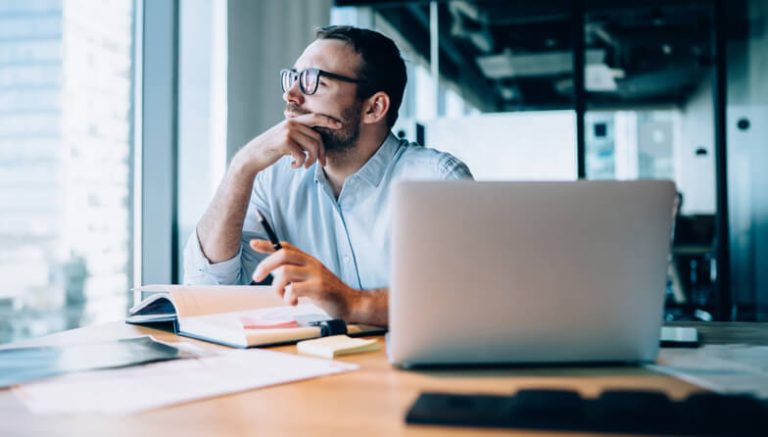 A focused male performance marketer working from home after completing his digital marketing course