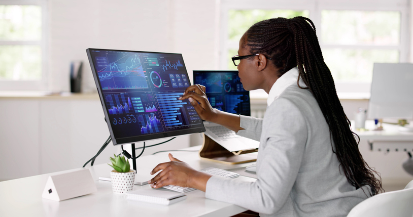 Female digital marketer studying analytics in an office after her digital marketing program