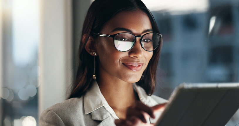 A smiling digital marketing specialist holding a tab after digital marketing training