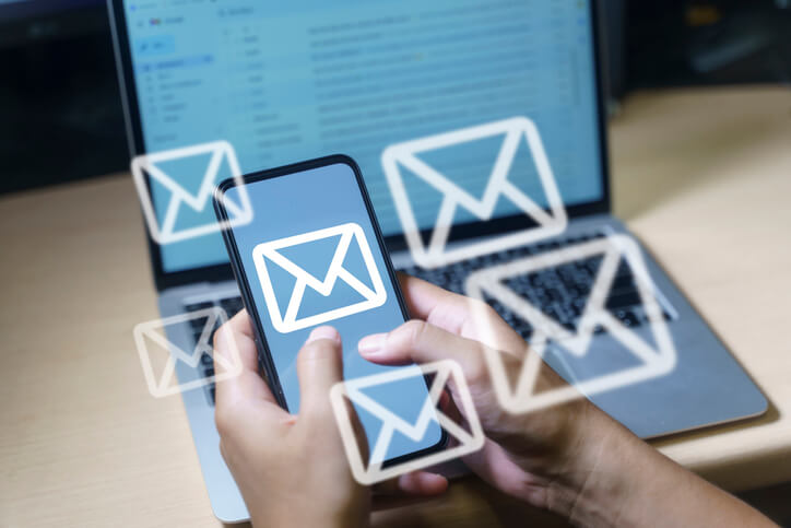 A digital marketing professional sending out emails in an office after completing his digital marketing training