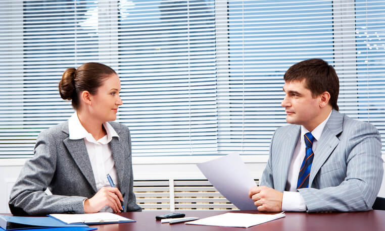 A male marketing data analyst being interviewed by a female employer after completing his digital marketing training