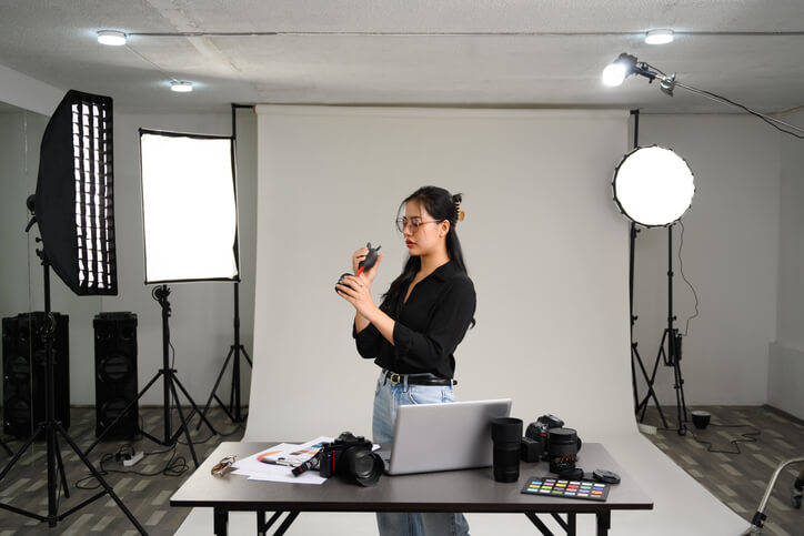 A content creator shooting short-form video marketing content in a brightly lit studio.