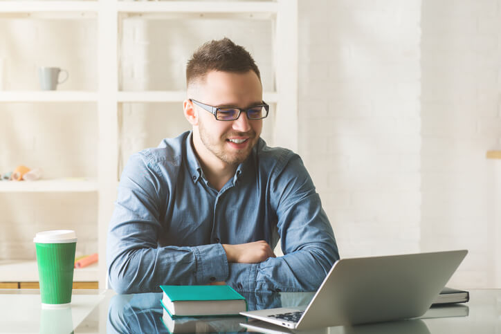 A digital marketer planning short-form video marketing content on a laptop.