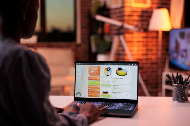 A digital marketer analyzing campaign data on a laptop after completing her diploma in digital marketing.